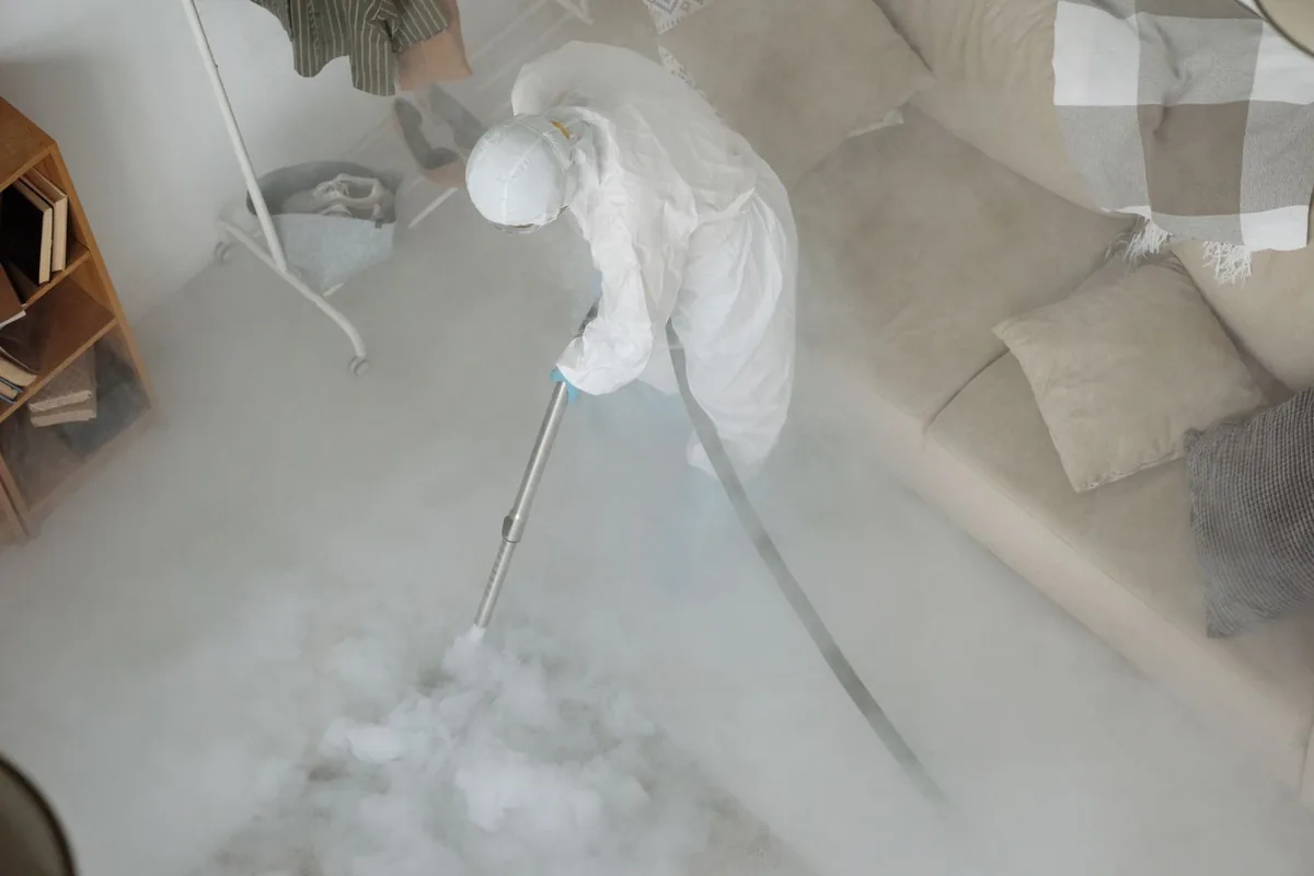 Biohazard cleanup technician in protective equipment, Mill Bay, AK